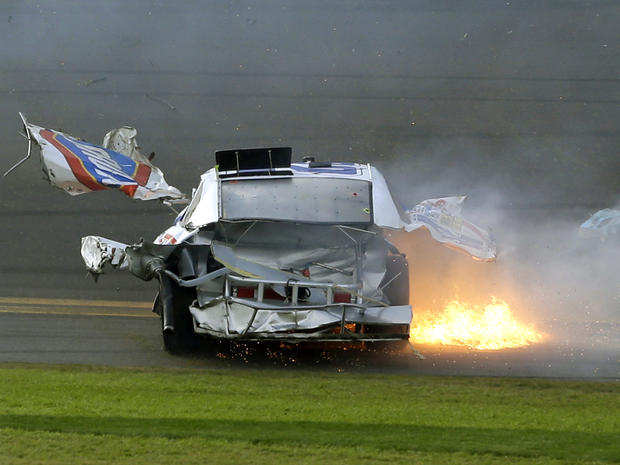 Pieces of Kyle Larson's car fly through the air as he slides down the front stretch after he was involved in a multi-car crash on the final lap of the NASCAR Nationwide Series auto race at Daytona International Speedway Feb. 23, 2013, in Daytona Beach, Fl 