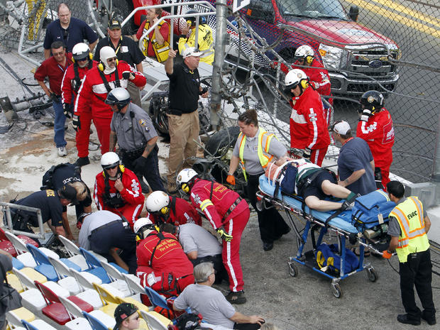 Injured spectators are treated after a crash at the conclusion of the NASCAR Nationwide Series auto race Feb. 23, 2013, at Daytona International Speedway in Daytona Beach, Fla. 