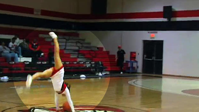 Cheerleader stuns crowd with half-court trick shot 