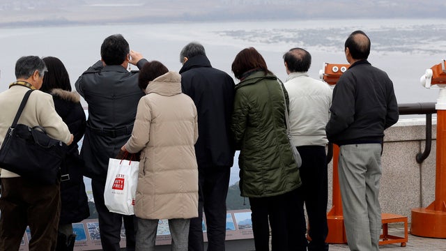 Tourists look at North Korea from the unification observation post near the border village of the Panmunjom (DMZ) that separates the two Koreas since the Korean War. 