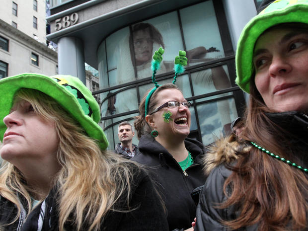 Donna Flanagan, of Palm Coast, Fla., left, her sister-in-law Cathleen Flanagan, of Setauket, N.Y., right, and others watch the St. Patrick's Day Parade as it makes its way up New York's Fifth Avenue March 16, 2013. 