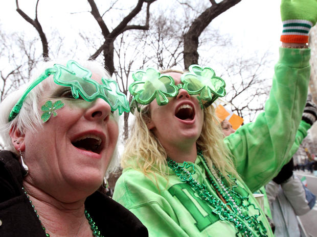 Kathy Brucia, of Bellmore, N.Y, left, and Kara Kerley, of Wantagh, N.Y., laugh as they watch the St. Patrick's Day Parade as it moves up New York's Fifth Avenue March 16, 2013. 