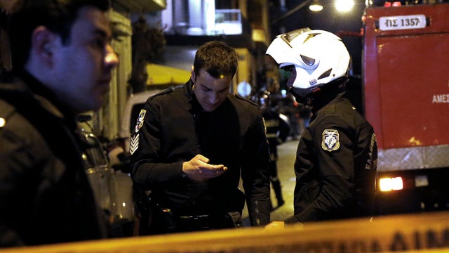 Police set up a cordon after a bomb exploded at the home of a Greek shipowner opposite the Acropolis in central Athens March 27, 2013. 