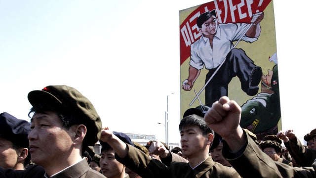 North Koreans punch the air during a rally at Kim Il Sung Square in downtown Pyongyang, North Korea, Friday, March 29, 2013. Tens of thousands of North Koreans turned out for the mass rally at the main square in Pyongyang in support of their leader Kim Jo 