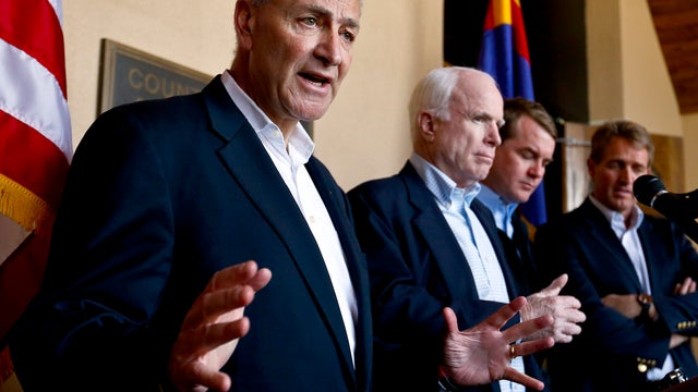 Sen. Chuck Schumer, D-N.Y., left, speaks to the media as, from second left, Sen. John McCain, R-Ariz., Sen. Michael Bennett, D-Colo., and Sen. Jeff Flake, R-Ariz., listen in during a news conference after their tour of the Mexico border with the United St 