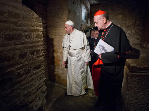 Pope Francis, followed by Cardinal Angelo Comastri, right, and Bishop Vittorio Lanzani, partially hidden, visits the necropolis on April 1, 2013. 
