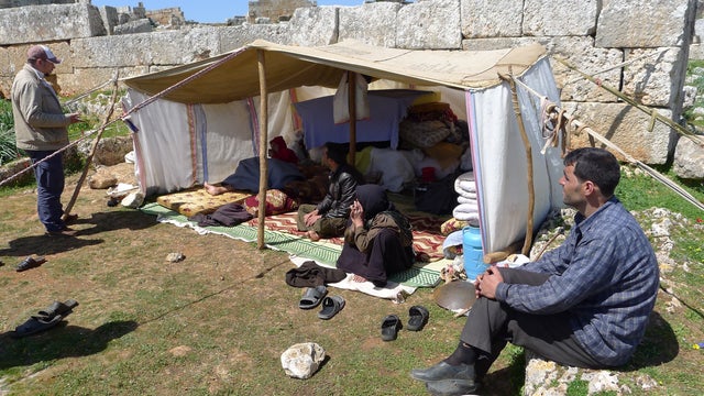 Hundreds of Syrians have fled life in the nation's heavily-bombed cities to try and dodge the artillery in ancient Roman ruins 