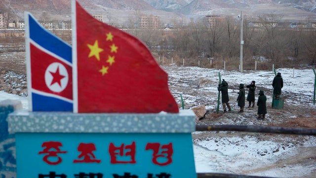 Chinese paramilitary police build a fence along the country's border withy North Korea. 