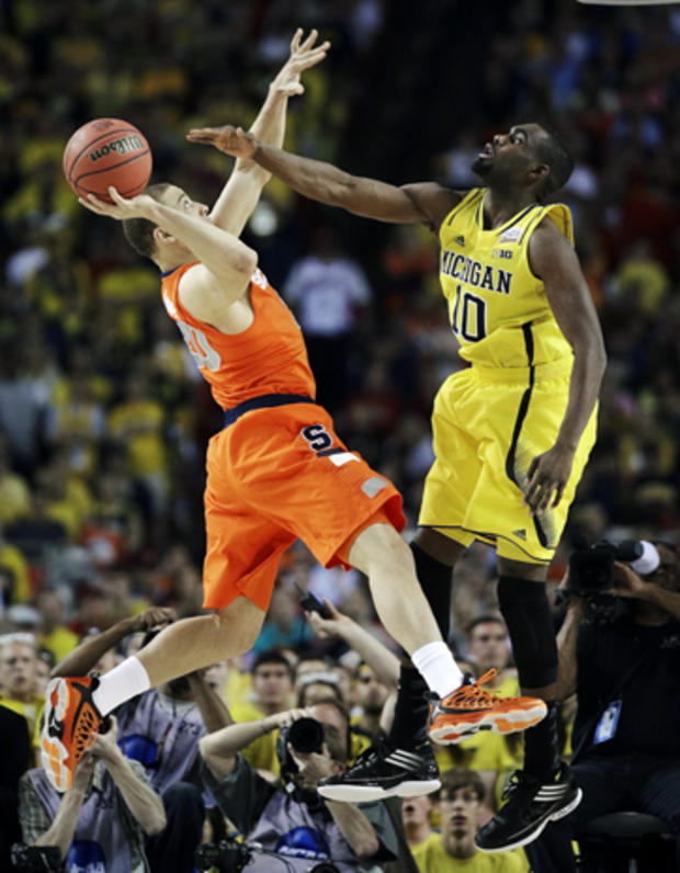 Syracuse's Brandon Triche (20) shoots against Michigan's Tim Hardaway Jr. (10) during the first half of a NCAA Final Four tournament college basketball semifinal game April 6, 2013, in Atlanta. 