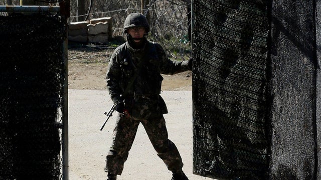 A South Korean soldier closes a military gate in Paju, north of Seoul, South Korea, Sunday, April 7, 2013.  