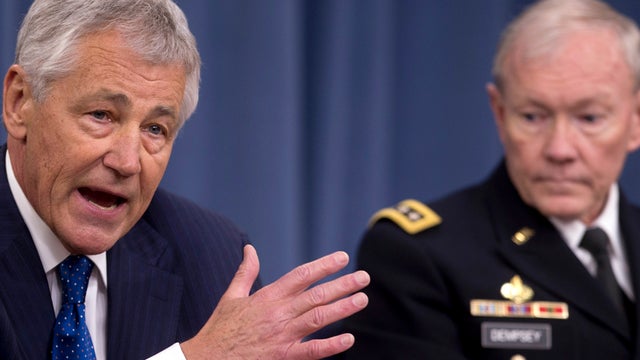 Defense Secretary Chuck Hagel, left, accompanied by Joint Chiefs Chairman Gen. Martin Dempsey, speaks during a news conference at the Pentagon April 10, 2013. 