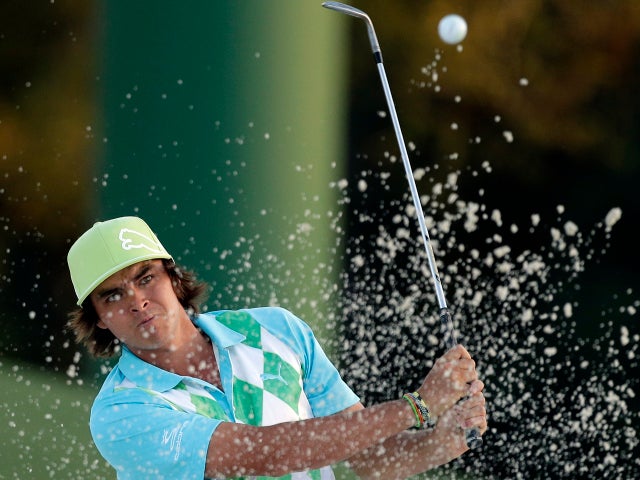 Rickie Fowler hits out of a bunker to the 18th hole during the second round of the Masters golf tournament April 12, 2013, in Augusta, Ga. 