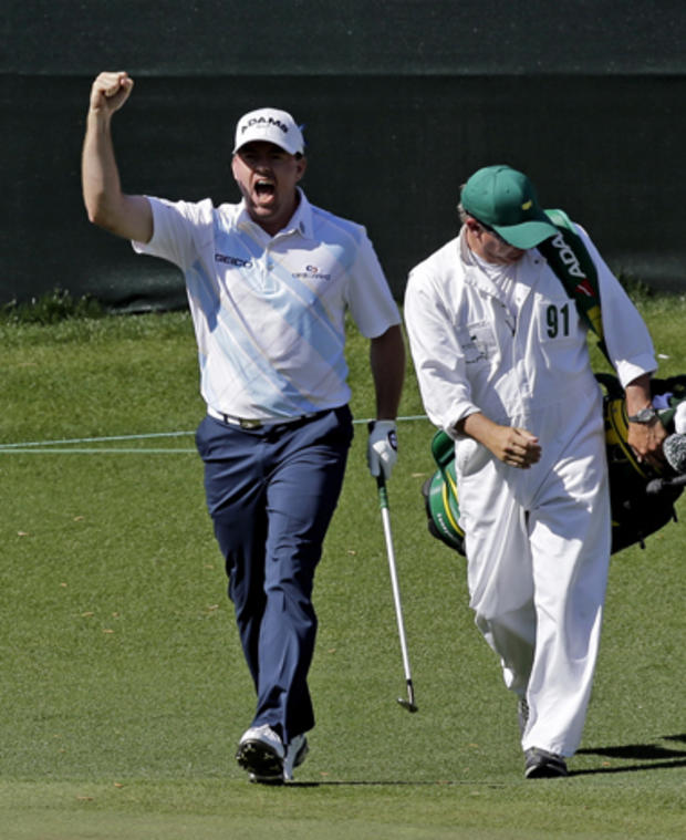 Robert Garrigus celebrates after chipping in for an eagle on the 15th hole during the second round of the Masters golf tournament April 12, 2013, in Augusta, Ga. Right is his caddie Brent Henley. 