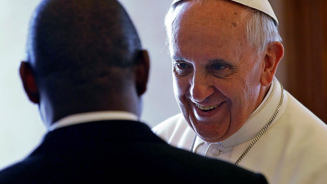 Pope Francis, right, meets with Mozambique's Prime Minister Alberto Vaquina on the occasion of their private audience in the pontiff's library at the Vatican April 11, 2013. 
