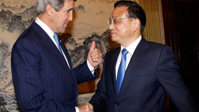 U.S. Secretary of State John Kerry, left, gestures while shaking hands with China's Premier Li Keqiang during a meeting at the Zhongnanhai compound in Beijing April 13, 2013. 