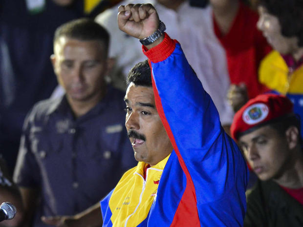 Venezuelan acting President Nicolas Maduro clench his fist while he celebrates after knowing the election results in Caracas on April 14, 2013. Venezuela's acting President Nicolas Maduro declared victory on Sunday in the race to succeed late leader Hugo Chavez after the electoral council announced that he had won in a close battle. 