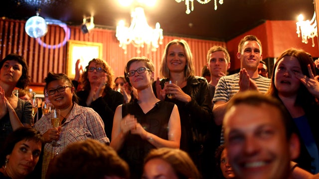 People watch Parliament coverage at a bar in Auckland as lawmakers approve a bill legalizing same-sex marriage 