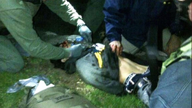 Dzhokhar Tsarnaev lies on the ground after being detained by police on Friday, April 19, 2013 