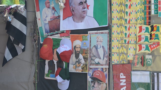 A poster praising Osama bin Laden is seen on a wall in Kuchlak, Pakistan 