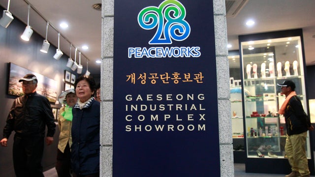 Visitors look at products made at Kaesong industrial complex in North Korea, displayed at the unification observation post in Paju 