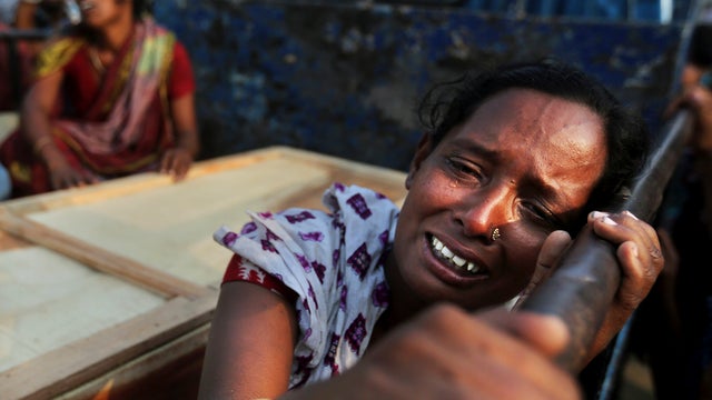 Bangladeshi woman weeps on April 28, 2013 as she sits next to coffin of relative who died in building that collapsed in Savar, near Dhaka, Bangladesh, several days earlier 