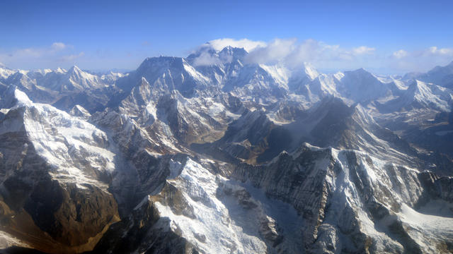 Mount Everest, center, and the Himalayan mountain range are seen some 87 miles northeast of Kathmandu April 3, 2013, the 80th anniversary of the first manned flight over Everest, the world's tallest mountain. 