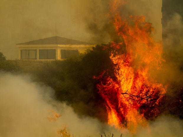 Flame and smoke rise from the naval base at Point Mugu, Calif., May 3, 2013. 