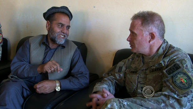 Special Operations Major General Tony Thomas talks to an Afghan man in his neighborhood. 