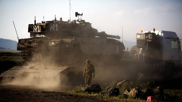 An Israeli Merkava tank is positioned for deployment during a drill in the Israeli annexed Golan Heights near the border with Syria on May 5, 2013. Israel carried out a pre-dawn air strike near Damascus, targeting Iranian missiles destined for Lebanon's H 