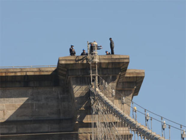 Police Officers Work To Talk A Man Off Of A Tower On The Brooklyn Bridge 