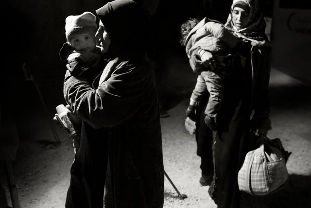 Syrian refugees wait to be processed by the United Nations High Commission on Refugees upon arrival the Zaatari camp 
