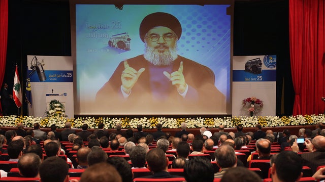 Hezbollah leader Sheik Hassan Nasrallah speaks via video during a conference, held in a southern suburb of Beirut, Lebanon, Thursday May, 9, 2013. Nasrallah said Syria will supply `game-changing' weapons to the Lebanese militant group. 