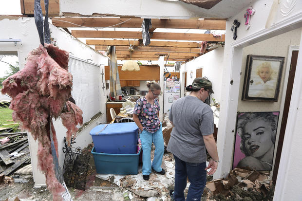 People look at damage as they help to start cleaning up and salvage items from a home that was destroyed by a tornado in Cleburne, Texas, Thursday, May 16, 2013. Ten tornadoes touched down in several small communities in Texas overnight, leaving at least  