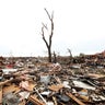 Massive piles of debris cover ground after powerful tornado ripped through Moore, Oklahoma on May 20, 2013 