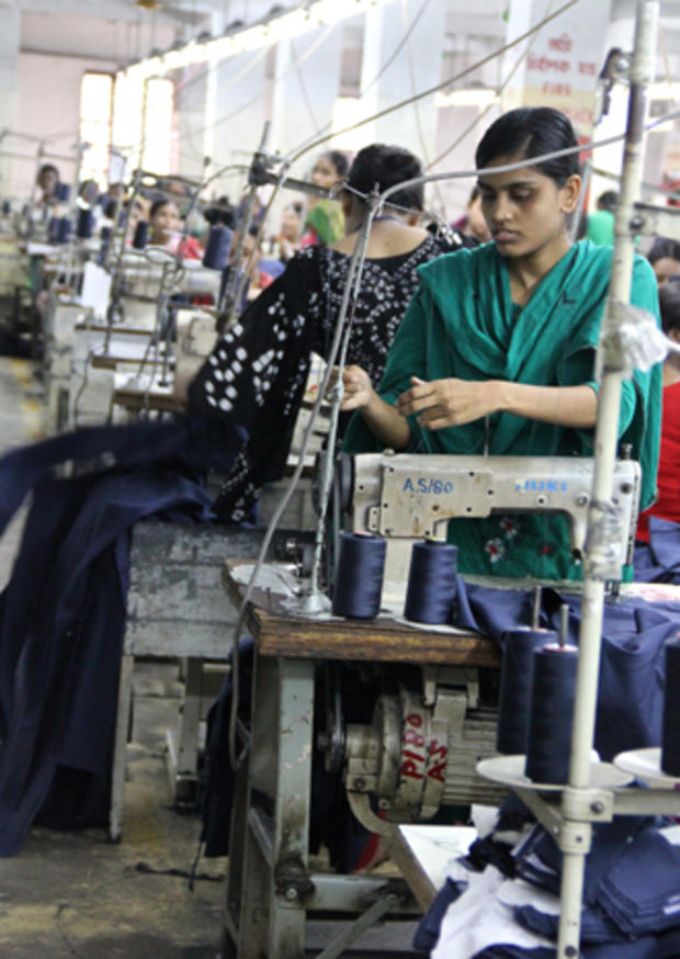 Workers sew garments in a factory in Dhaka, Bangladesh.  
