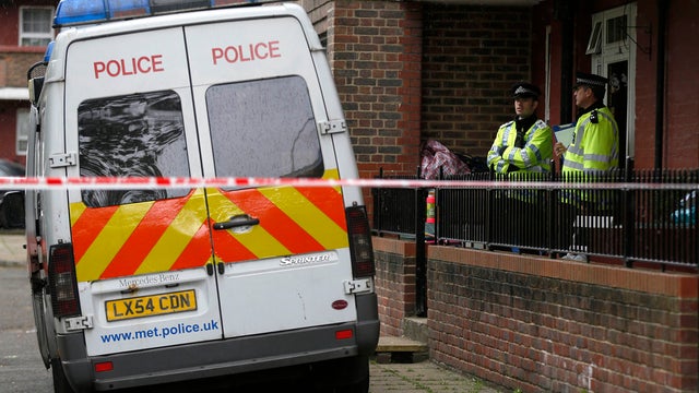 Police officers guard a flat as it is being searched at Greenwich, southeast London, May 23, 2013. 
