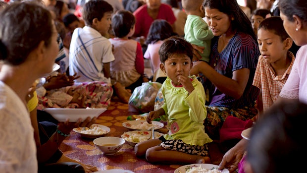 Muslims eat a meal at a Buddhist temple following sectarian violence in Lashio, northern Shan State, Myanmar, Thursday, May 30, 2013. 