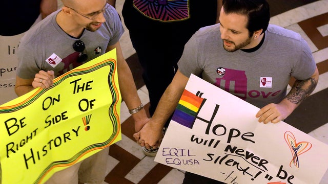Supporters of Illinois' same-sex marriage legislation hold hands and sing songs in the rotunda at the Illinois State Capitol May 31, 2013, in Springfield, Ill. 