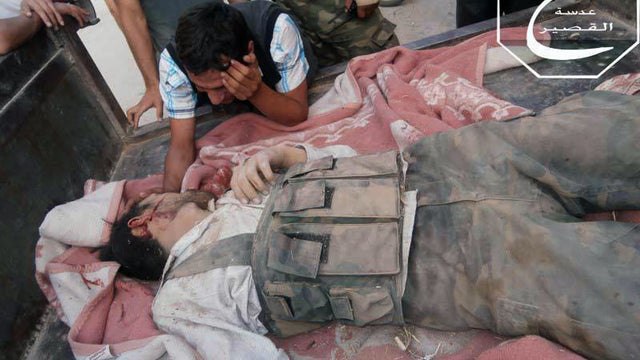 man mourning next to his brothers body 
