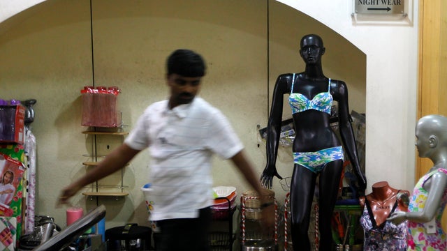A man walks past a mannequin displaying lingerie at a mall in Mumbai 