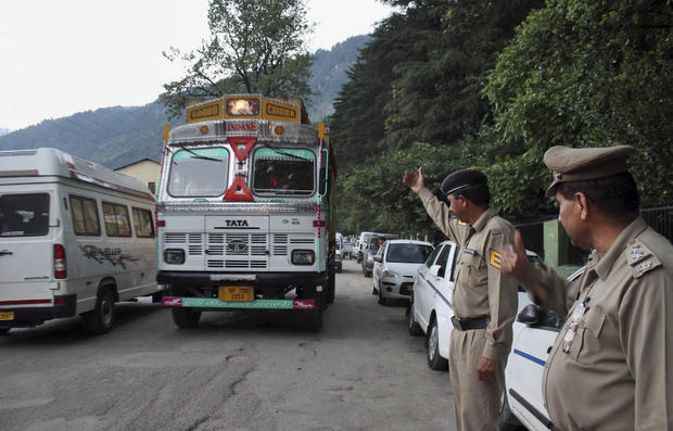 Indian policemen check vehicles after an American woman was gang-raped in the northern Indian resort town of Manali 
