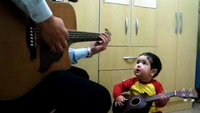 Adorable father and son sing The Beatles 