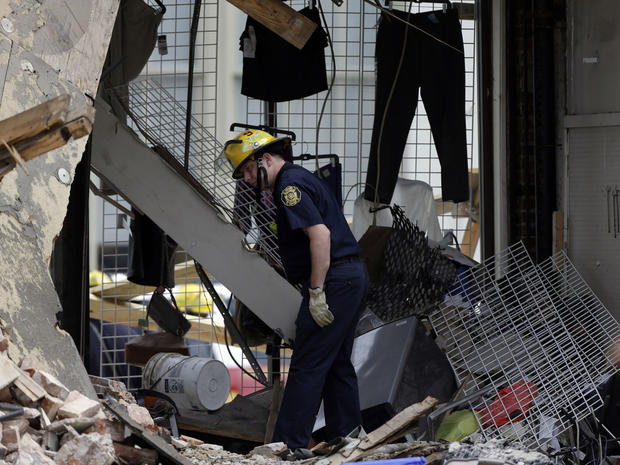 firefighter walks through the aftermath of a building collapse, Thursday, June 6, 2013, in Philadelphia. On Wednesday, the building under demolition collapsed onto a neighboring thrift store, killing six people and injuring 13. 