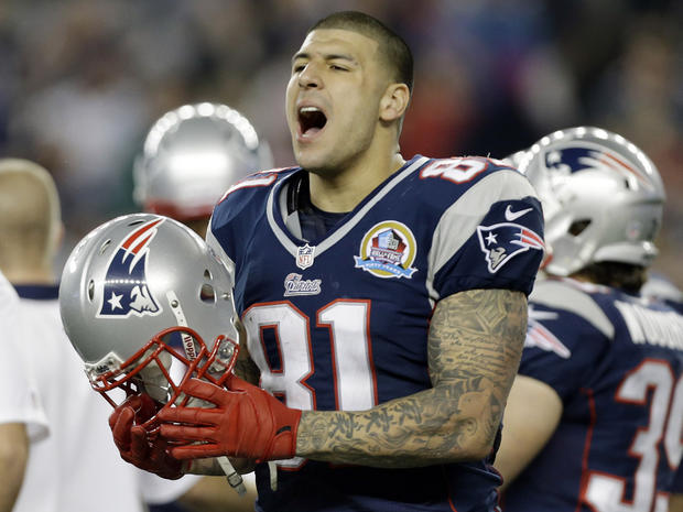 In December 2012 file photo, New England Patriots tight end Aaron Hernandez reacts during the second quarter of an NFL football game against the Houston Texans in Foxborough, Mass. State and local police spent hours at the home of New England Patriots tight end Aaron Hernandez on Tuesday June 18, 2013 as another group of officers searched an industrial park about a mile away where a body was discovered the day before. 
