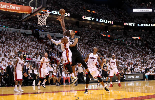 Tim Duncan of the San Antonio Spurs shoots the ball over Dwyane Wade of the Miami Heat in the third quarter during Game 7 of the 2013 NBA Finals at American Airlines Arena on June 20, 2013 in Miami, Florida.  