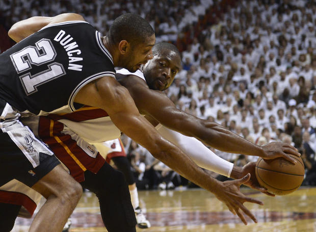 Dwyane Wade (R) of the Miami Heat is guarded by Tim Duncan (L) of the San Antonio Spurs in the first half during Game 7 of the NBA Finals at the American Airlines Arena June 20, 2013 in Miami, Florida. 