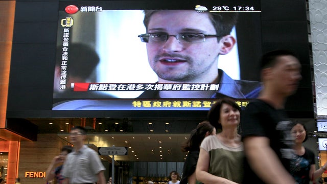 A TV screen shows a news report of Edward Snowden, a former CIA employee who leaked top-secret documents about sweeping U.S. surveillance programs, at a shopping mall in Hong Kong Sunday, June 23, 2013.  