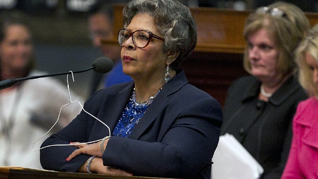 Rep. Senfronia Thompson, D-Houston, stands at the podium where she has hung a hanger from the microphone on the House floor as she attempts to add an amendment to create an exception for victims of rape and incest in Senate Bill 5 during debate at the Sta 