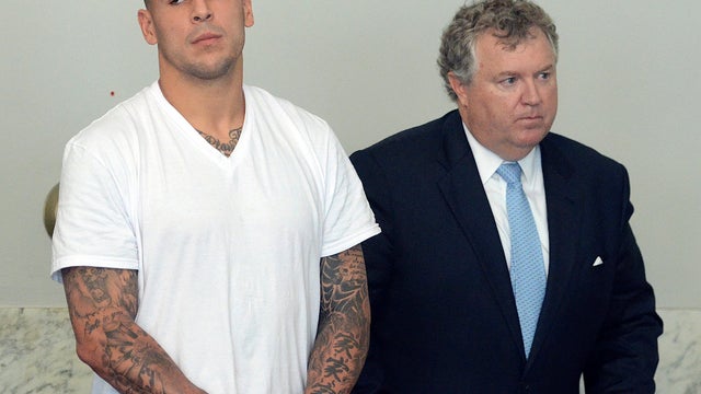 New England Patriots tight end Aaron Hernandez, left, stands with his attorney, Michael Fee, right, in Attleboro District Court June 26, 2013, in Attleboro, Mass. 