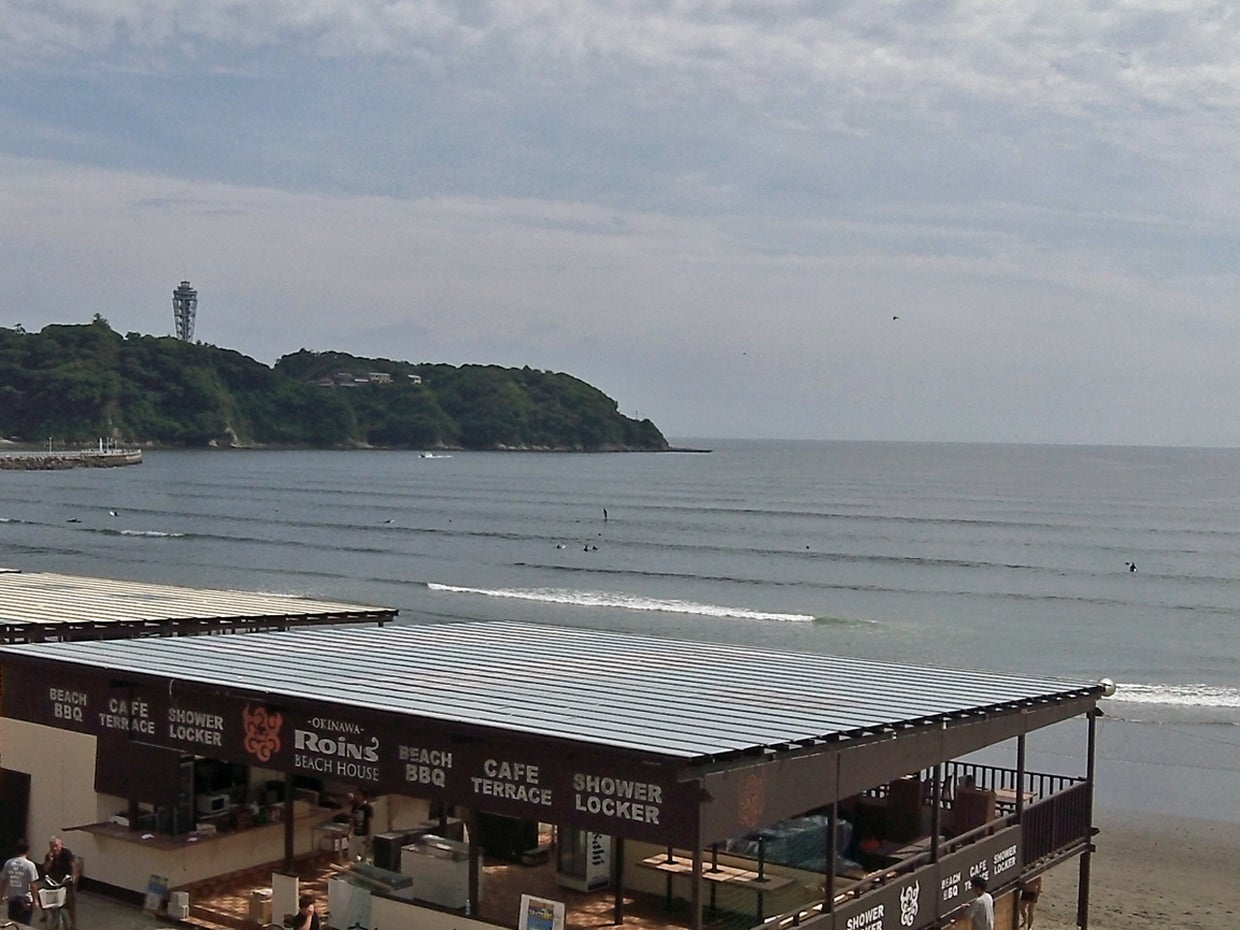 Windsurfers enjoy the early summer waves in the Japanese beach resort of Enoshima 